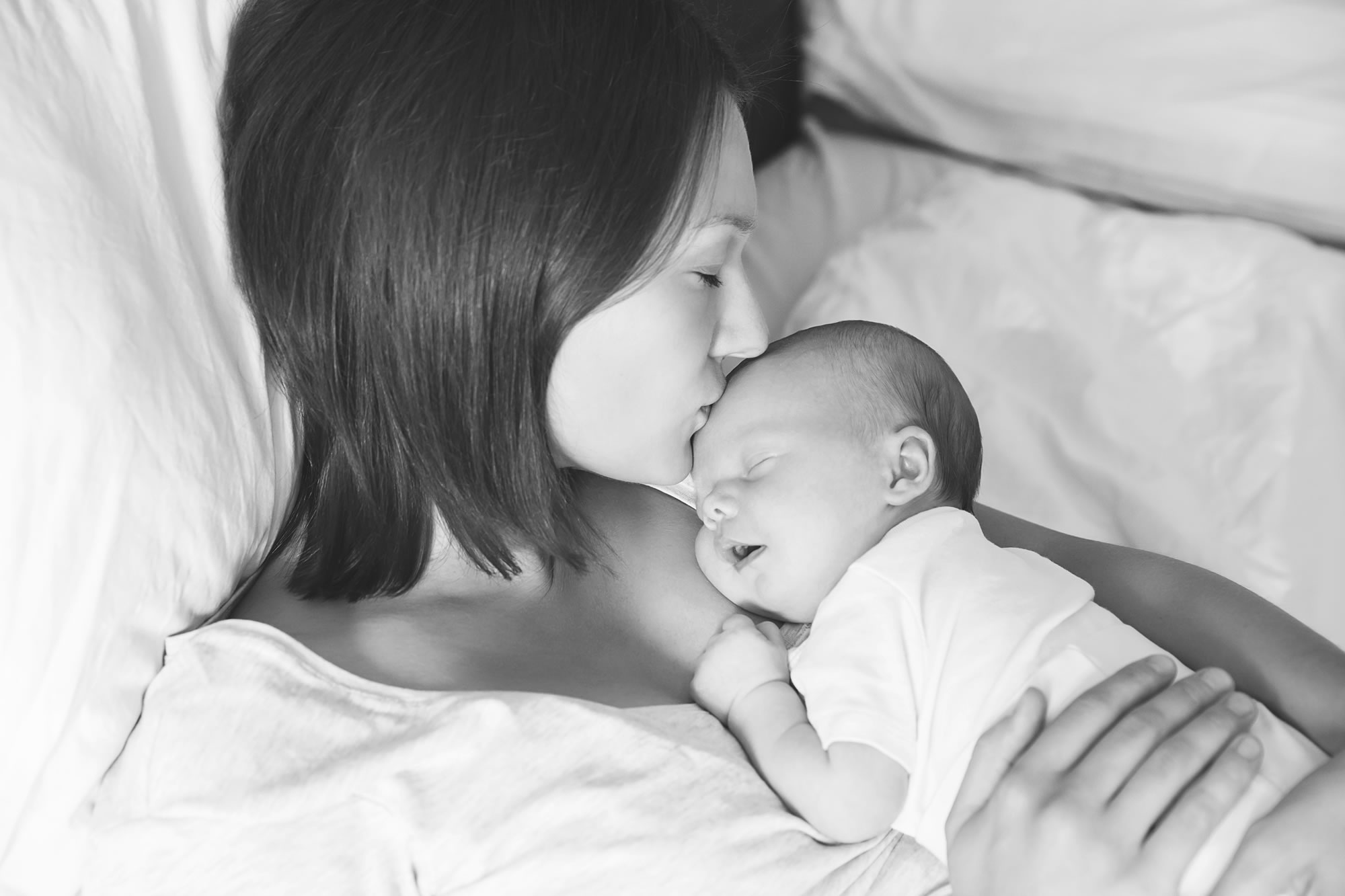 "Woman kissing newborn | OBHG"