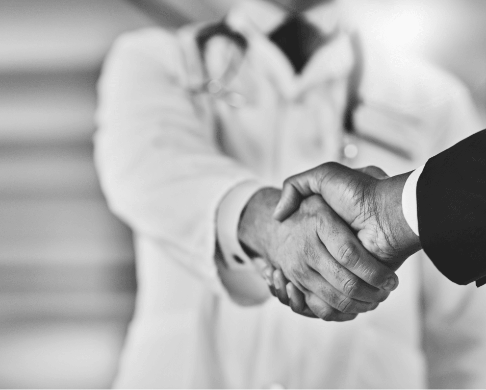 "Doctor shaking hands with business person | OBHG"